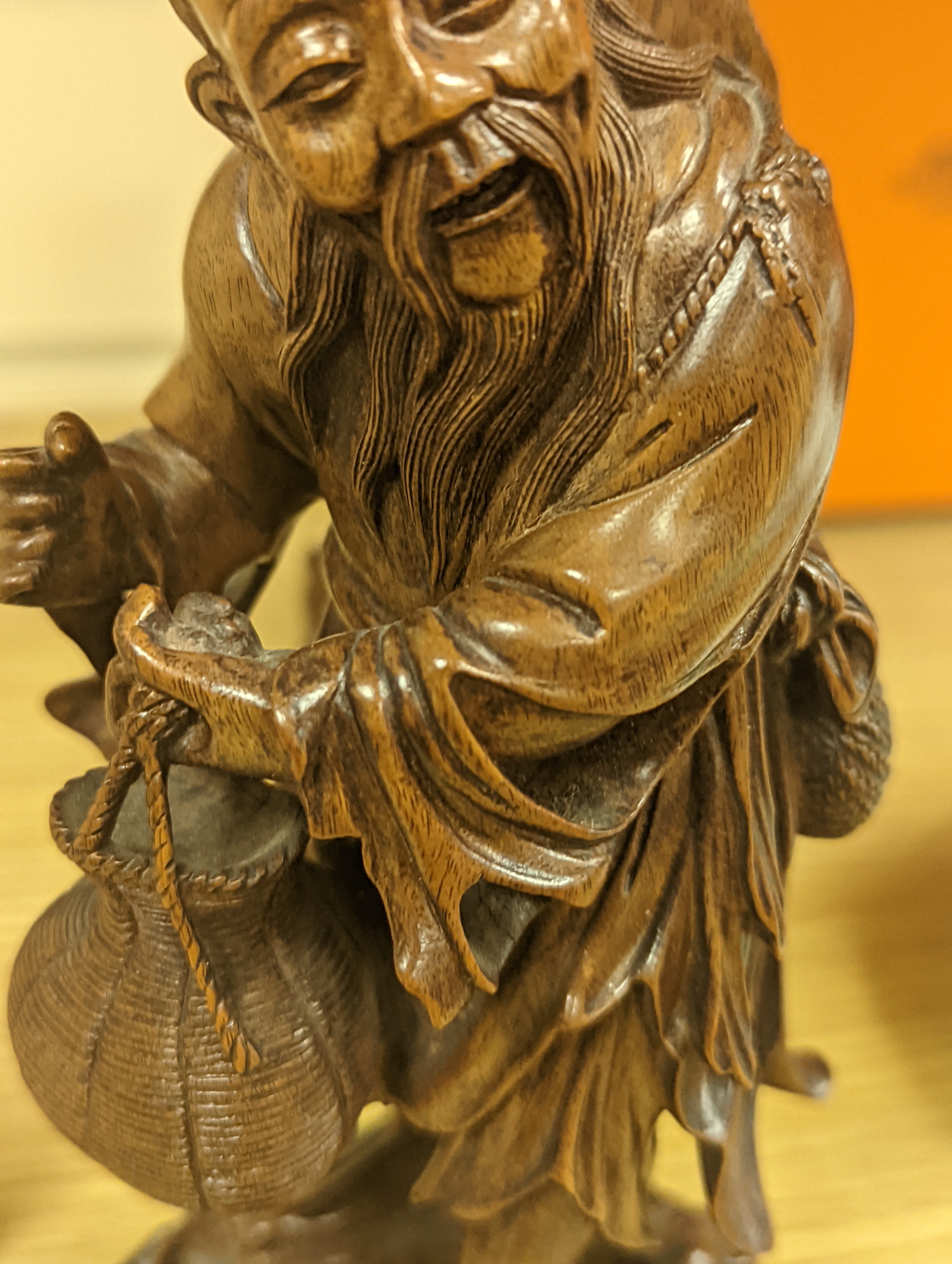 Two Chinese hardwood figures of a fisherman and a old man holding peaches 16cm